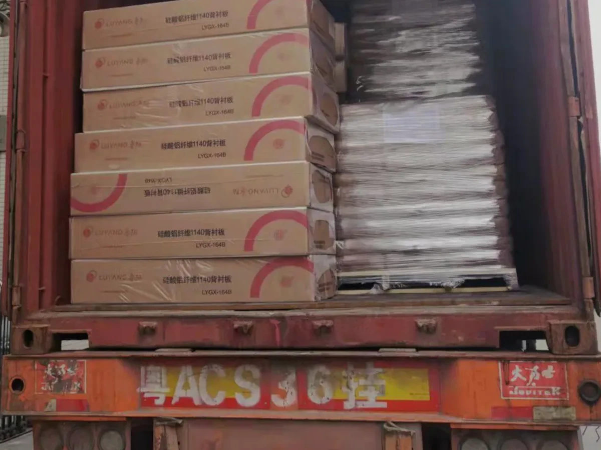 Export cartons being loaded onto the back of a container truck during origin-side cargo handling